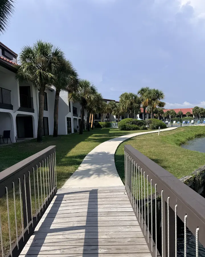 Boardwalk and paved path running alongside the low-rise Edgewater Golf Villas buildings, Panama City Beach.